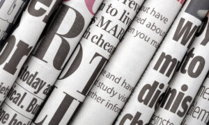 5 weird Canadian Gambling News Stories_Newspaper headlines shown side on in a stack of daily newspapers