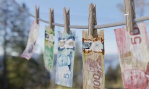 Various Canadian bills drying on a laundry line. Cullen report slams gov, BCLC, finds billions laundered in BC casinos