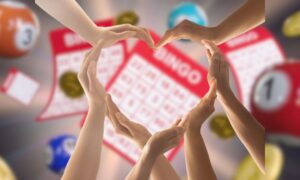 Hands forming a heart over bingo cards for story on Ontario communities getting more than $460 million from Ontario Charitable Gambling