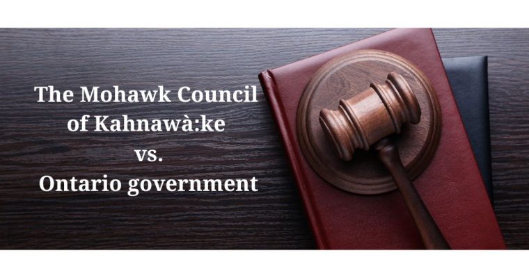 Gavel on a desk beside the words: The Mohawk Council of Kahnawà:ke vs. the Ontario government. The court challenge is to determine the legality of the Ontario online gambling sector.