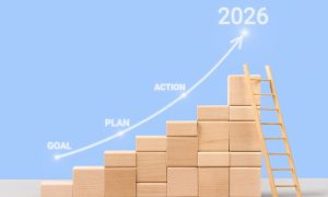 Wooden blocks stacked as stairs with a ladder and upward arrow pointing to 2026, illustrating iGaming market growth through goal, plan, and action