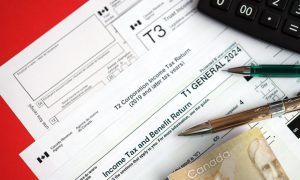 Canadian corporation tax return forms alongside Canadian currency and a calculator