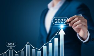 Business professional drawing an upward growth trend on a digital bar chart, highlighting a rise from 2024 to 2025